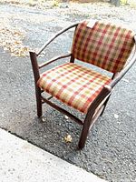 Full view of armchair showing wood twig frame and plaid upholstery
