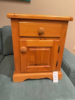 Front view showing drawer, door and knobs
