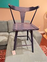 Front view of blue wooden Danish-style stool