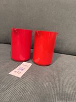 Two red Rosti jugs front view