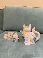 Full tea set showing teapot, sugar bowl with spoon, and creamer