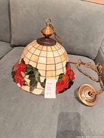 Full view of stained glass pendant light on sofa