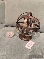 Full view of iron orb flush mount fixture with canopy and bulbs