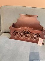 Front view of carved wooden church pew shelf