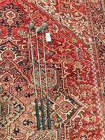 Three golf clubs full length on rug
