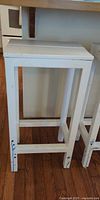 Single white wood bar stool front view