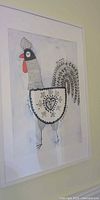 Framed rooster artwork on wall, full view
