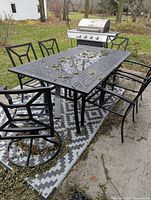 Full set showing table, six chairs, rug