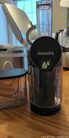 Front view of Philips juicer showing logo, feed tube and pulp container