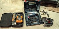 All three power tools laid out: Ridgid multi-tool set, Bosch drill in case, Skil jigsaw