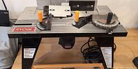 Full view of Ryobi router table with fences and miter gauges