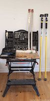 Overall lot showing workbench, tool set, piano hinges and drywall poles