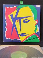 Front cover of XTC Drums and Wires LP with vinyl partially visible