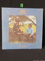 Front cover showing title, artist and photo, shrink wrap visible