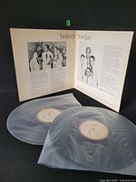 Both translucent vinyl discs with labels visible