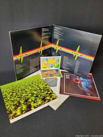 Gatefold opened showing inside artwork, posters, stickers, inner sleeve