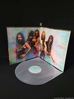 Gatefold open showing both inner panels and vinyl in translucent sleeve