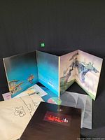 Full set laid out: outer gatefold, three vinyl discs, three inner sleeves, two booklets