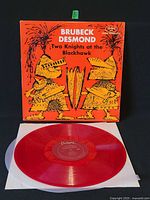 Front jacket with red vinyl LP partially removed