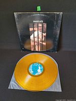 Front jacket and yellow vinyl record displayed