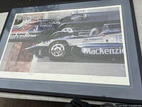 Full view of framed lithograph showing racing cars and frame
