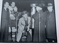 Overall view of unframed 20"x16" black and white hockey photo with Stanley Cup