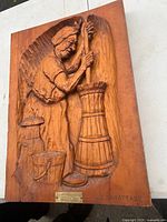 Full view of carved wood plaque on table