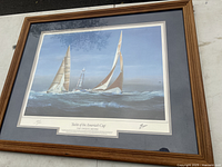 Full view of framed print with wood frame and marine scene