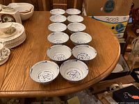 All twelve blue and white bowls arranged on table