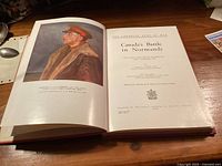 Open book showing frontispiece portrait and title page