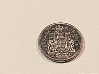 Reverse side showing Canadian coat of arms and date