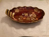 Top view of Carlton Ware Rouge Royale oval dish showing grapevine design and handle