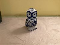 Front view of blue and white ceramic owl figurine