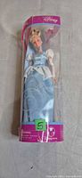 Front view of sealed Disney Store Cinderella doll in clear plastic tube