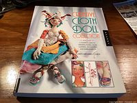 Front cover of the book showing title, subtitle, author, and doll imagery