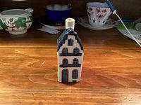 Front view of Delft Blue KLM house bottle showing façade and cap