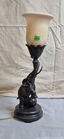 Full view of elephant base lamp with frosted shade