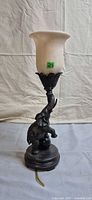 Full view of elephant lamp with glass shade