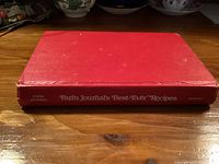 Closed red hardcover cookbook, spine text visible
