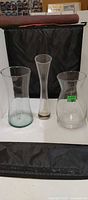 All three clear glass vases displayed together