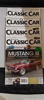 Stack of four Hemmings Classic Car magazines showing assorted covers
