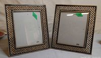 Front view of both picture frames showing lattice gold-tone borders and glass fronts