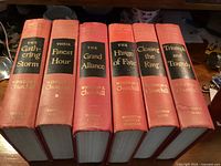 Spines of all six volumes showing titles and publisher