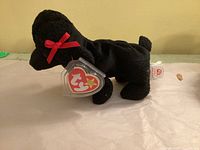 Left side profile of Gigi showing swing tag and overall condition