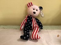 Front view of Ty Tangle the Bear showing patriotic pattern and hangtag