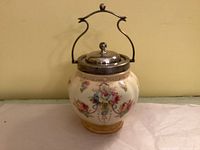 Front view of Crown Devon Wye biscuit barrel showing floral decoration, lid, and handle