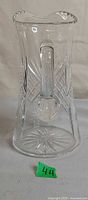 Front view of clear crystal jug with diamond and starburst cuts, applied handle visible