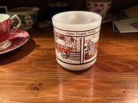 Front view showing two village buildings and Upper Canada Village text