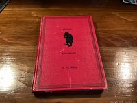 Front cover of red cloth hardcover book with title and silhouette