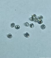 Group of loose round diamonds on light background